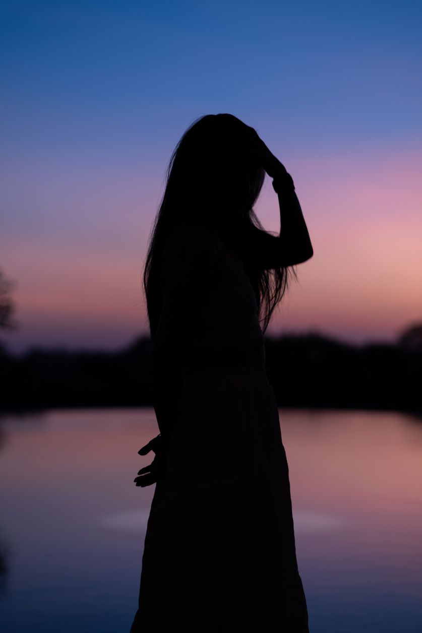 A beautiful pink sunset behind her.
